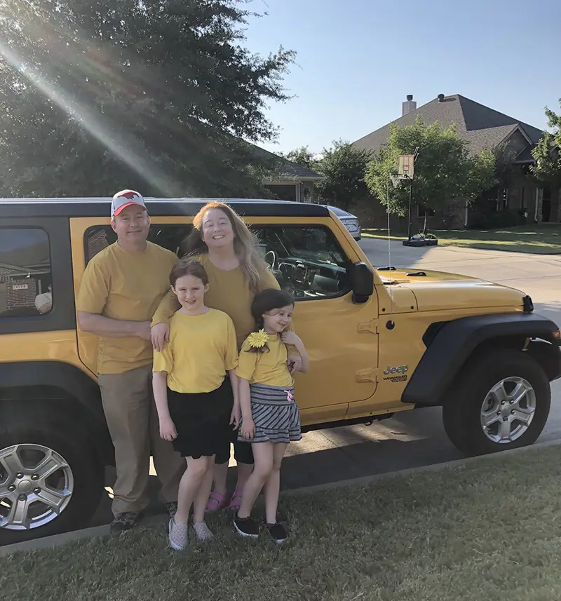 Bruce, Karina, Kitty, and Phoebe pose in front of the Yella Jeep.  I think God might be photobombing.